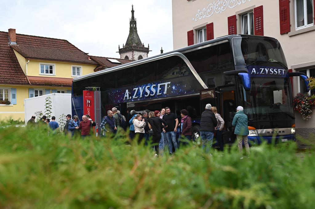 Der Zysset-Car vor dem Restaurant Kreuz. Im Vordergrund eine unscharfe Hecke.