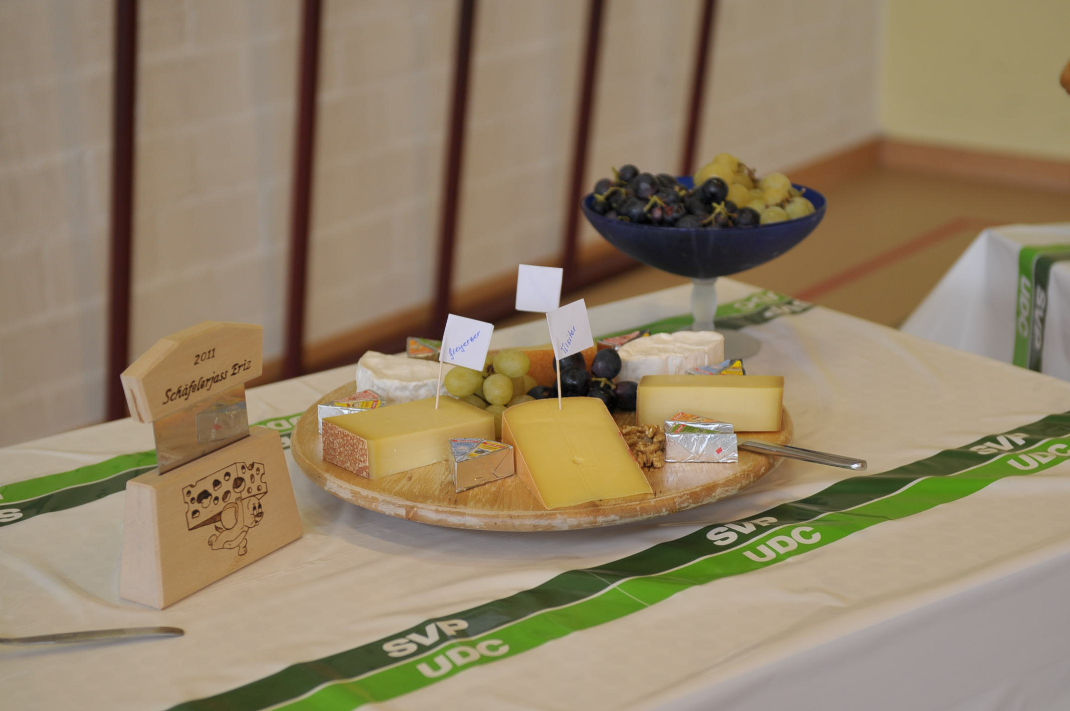 Käseplatte auf Tisch mit SVP-Logo.